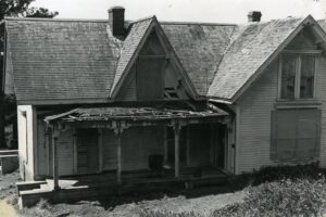 Elevated view of a dilapidated house with a front porch