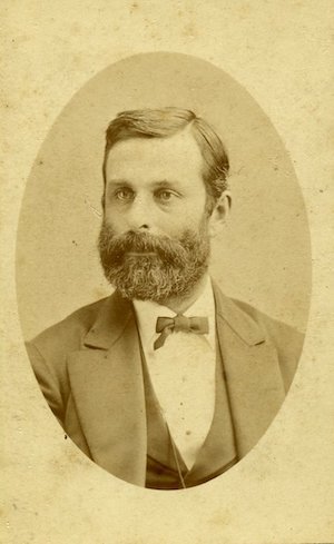Studio portrait of a bearded man in a suit