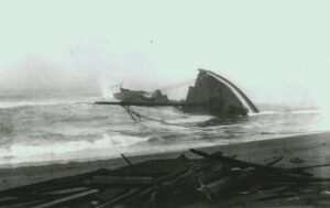 Wreckage of a ship in the water and on the beach