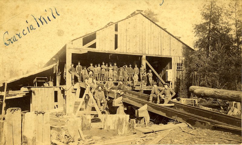 Group of men with hats standing in front of building