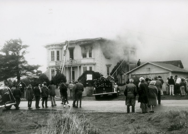 Onlookers observe firefighters at house fire