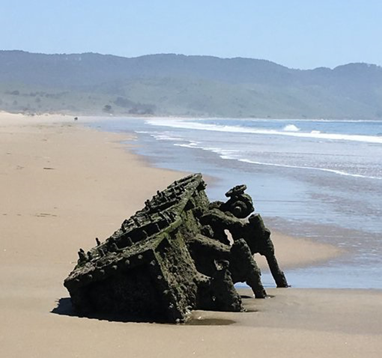 Riveted machinery partially visible on beach