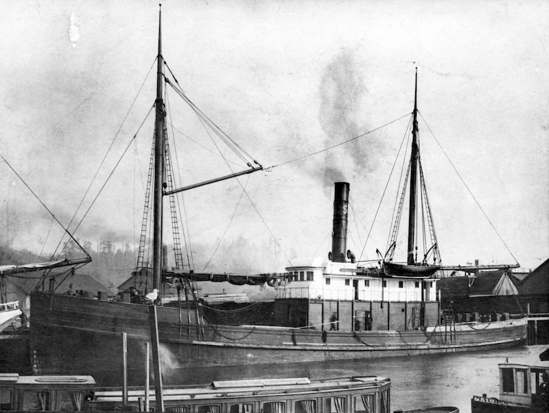 Docked ship with masts and steam pipe
