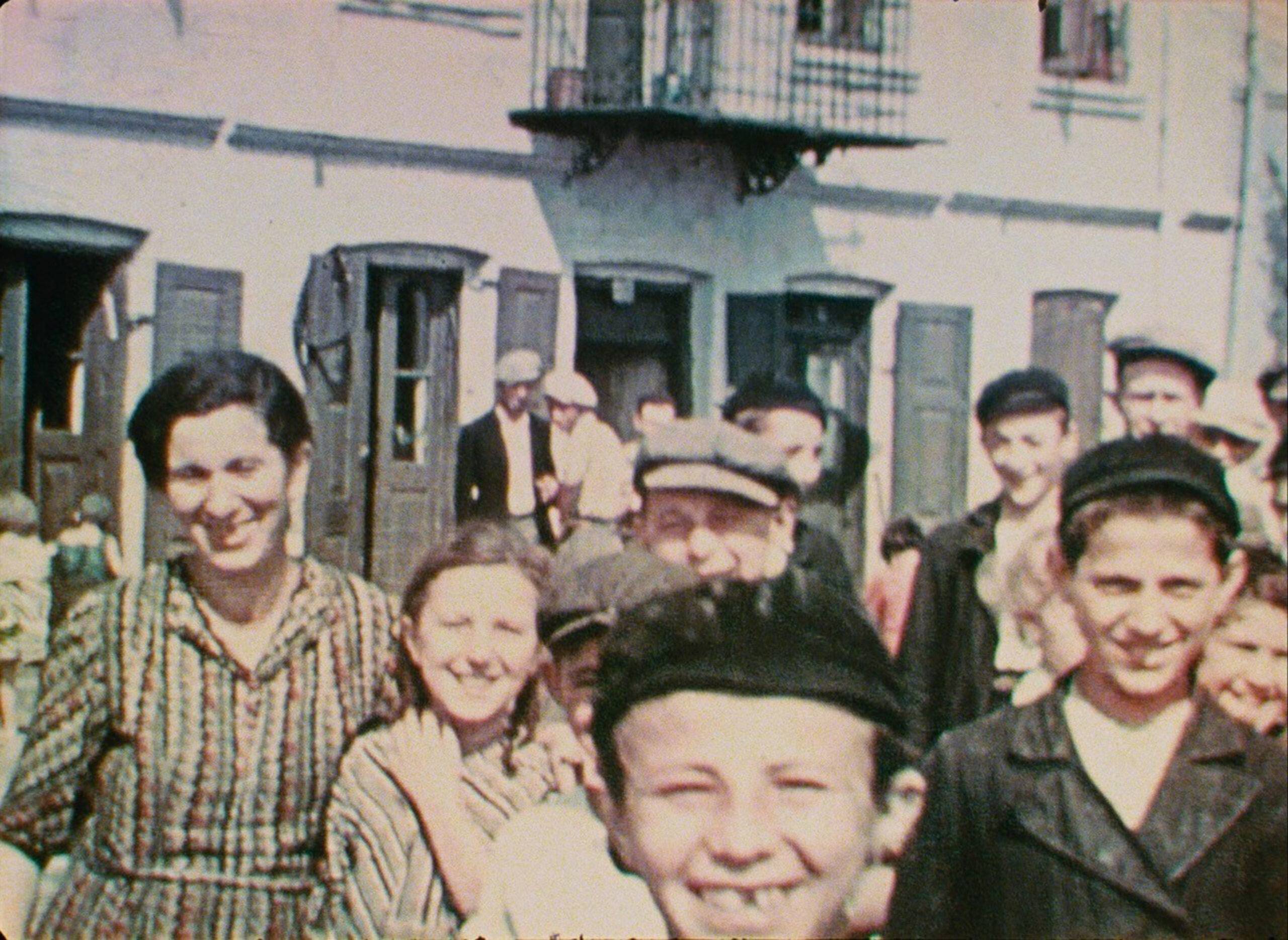 A still from "Three Minutes: A Lengthening" shows the people of Nasielsk smiling for the movie camera in 1938.