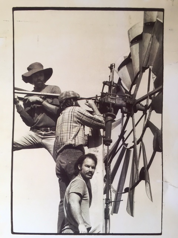 Three men working on a windmill