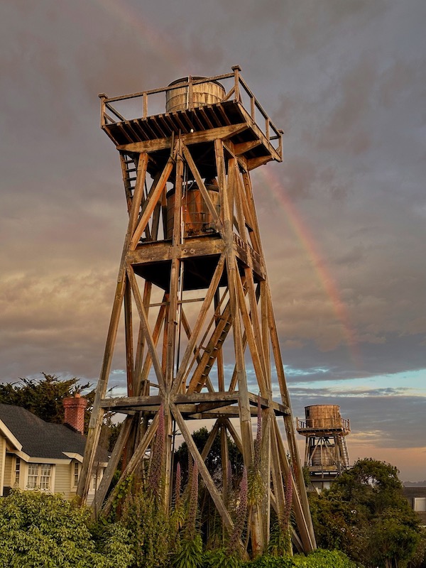 Two water towers with rainbow