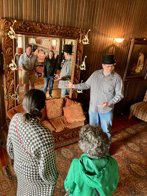 People viewing an ornate mirror