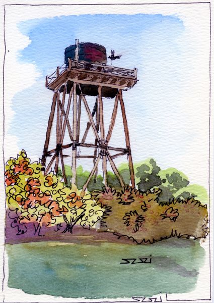 water tower with bird surrounded by flowers