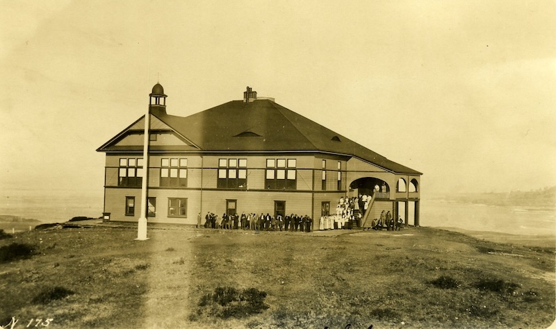 Queen Anne Style two-story building. Student pose on the exterior staircase.
