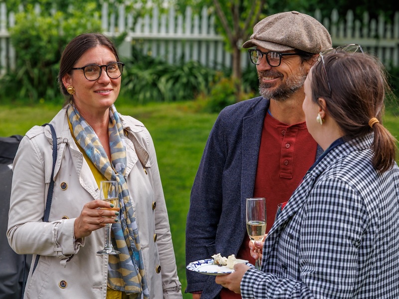 Two women and a man at a party