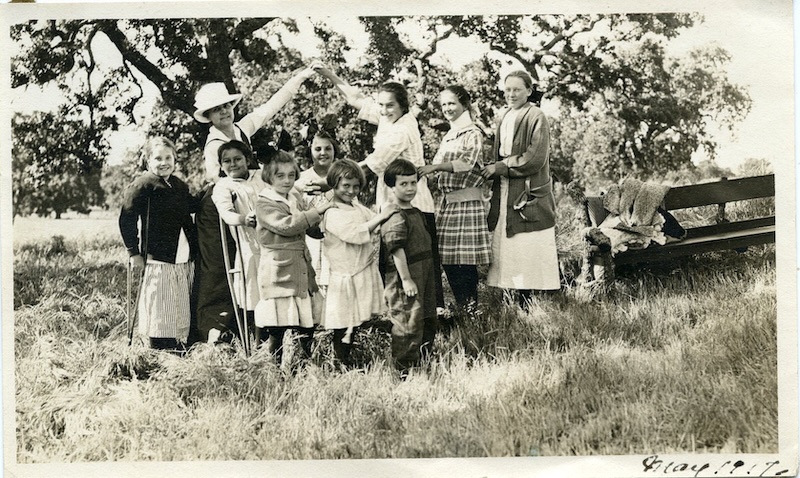 Women and children celebrating on a lawn