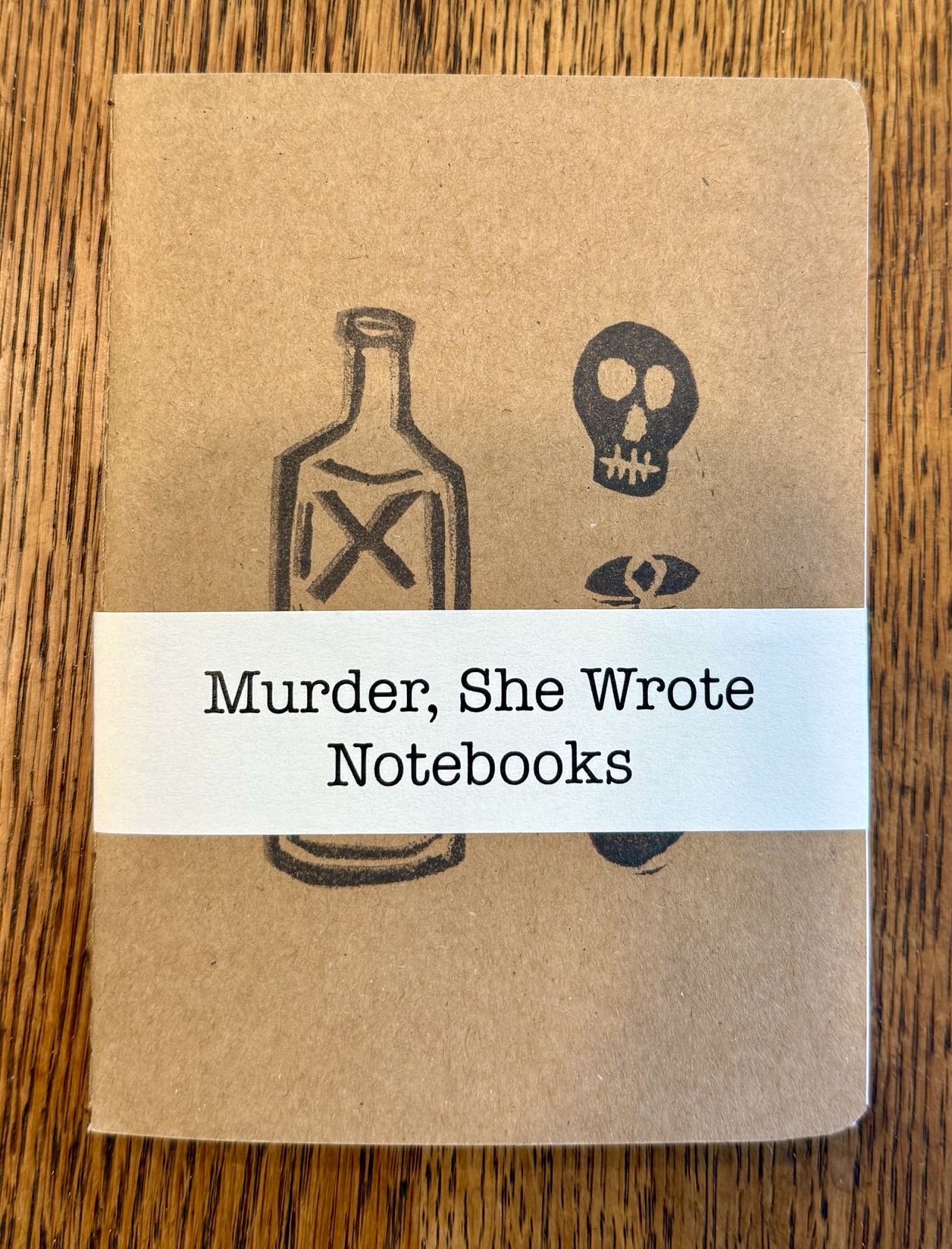 brown book with stamped images of bottle and skull