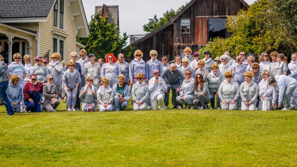 people in short white wigs dressed in gray track suits