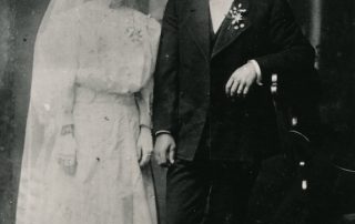 Woman and Man stand next to each other in wedding attire