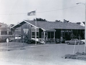 A building with an American flag flying from a pole in front of it