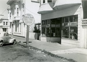 A store with a round sign on a pole out front reading "The Remedy Store"