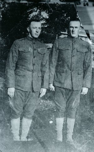 Two men in World War 1 army uniforms standing outdoors