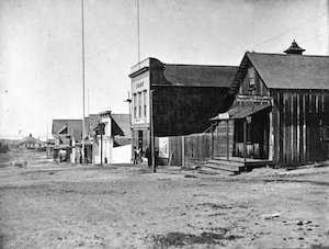 Various buildings along a wide dirt street