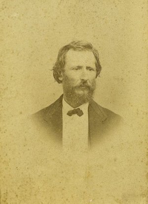 Studio portrait of a bearded man in a suit