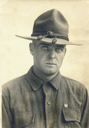 Army portrait of a young man in a button-down shirt and hat