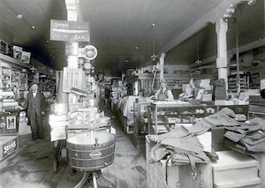 Two men standing in a store full of merchandise and shelves