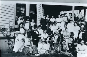 Large group of women outside a building posing for a photo