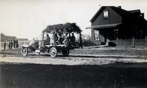 Old fashioned car in the street in front of a house