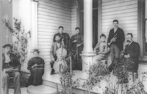 Group of musicians with instruments on a house's porch