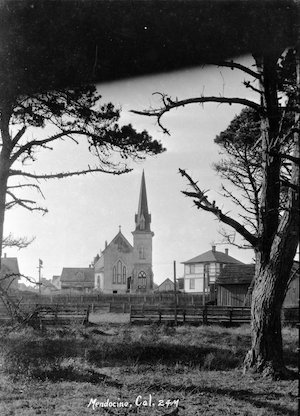 Distant view of a church with steeple and building next to it