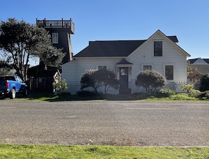 White house with wooden water tower to the side