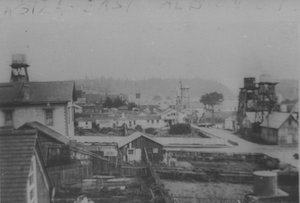 Elevated view of a town with buildings, streets and water towers