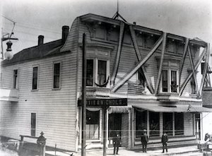A two-story building with bunting draped from the roof