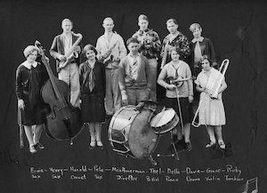A group of teenagers holding various musical instruments