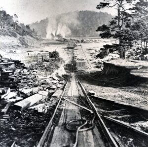 Train tracks running from a lumber mill