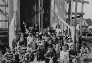 Large group of children on front steps of a church