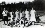 Campfire Girls on Big River Beach in various states of dress, from uniforms to bloomers to swim suits, 1926. Standing, L. to R.: Eva Walton, Harvena Davies, Gleneice Silvia, Irene Granskog, Evelyn Bowman, Merna Brown, Mary Silvia. Sitting, L. to R.: Helen Tyrrell, Edna Freathy, Jane Cleary, Ruby Carvalho.