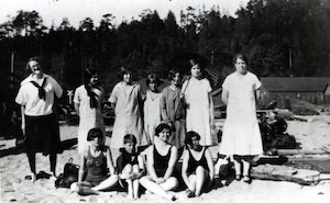 Group of girls standing and sitting outdoors