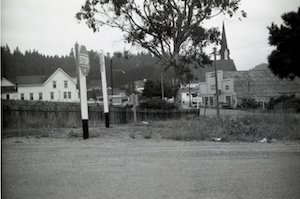 Street intersection with stop sign and buildings in the background