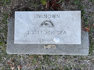 Small gravestone that reads "Unknown, Lost to the Sea, c. 1860"