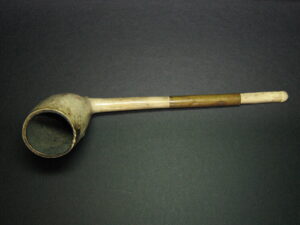 White smoking pipe with copper banding on the handle