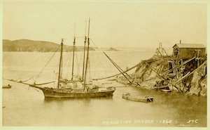 Schooners in Mendocino Harbor, 1865. Two sailing ships at the Mendocino shipping point are being loading with lumber. A lighter, or loading boat, is in the water near the apron chutes on the right. Kent's Point (later Chapman's Point) is visible in the background. (Kelley House Collection, Kelley House Photographs)