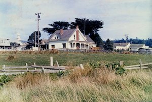 House in grassy field with wooden fence in 1975