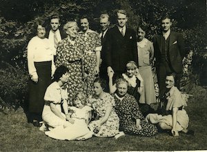 Family group posing outside facing camera