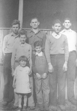 Seven children standing and facing the camera