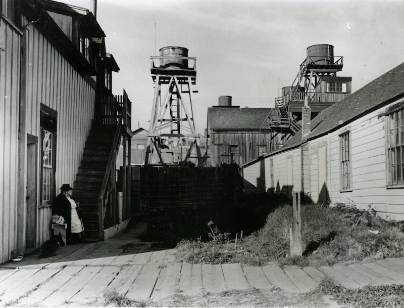 Water towers rise above buildings